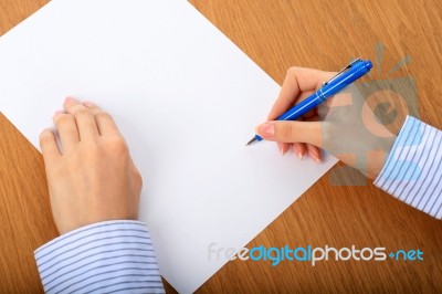 Female Hand Signing Contract Stock Photo