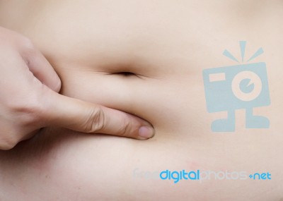 Female Hand Touching Fatty Stomach Stock Photo