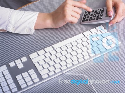 Female Hand Using Calculator Stock Photo