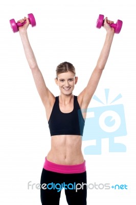 Female Instructor Showing How To Lift Dumbbells Stock Photo