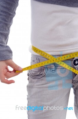 Female Measuring Her Waist With Tape Stock Photo