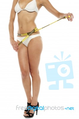 Female Model With A Inch Tape Around Her Waist Stock Photo