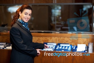 Female Receptionist Holding Records Stock Photo