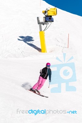 Female Skier In Fresh Powder Snow And Blue Sky Stock Photo