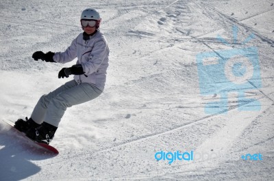 Female Snowboarder In Powder Snow Stock Photo