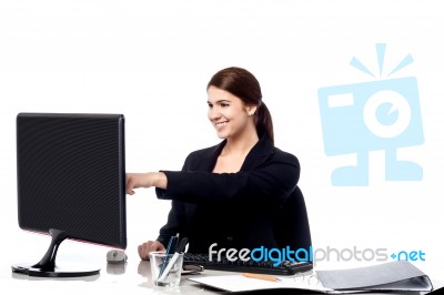 Female Staff Pointing At Monitor Screen Stock Photo