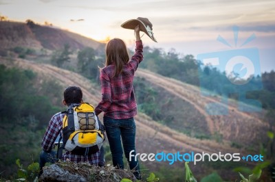 Female Tourists And Men Are Viewing The Mountain Stock Photo