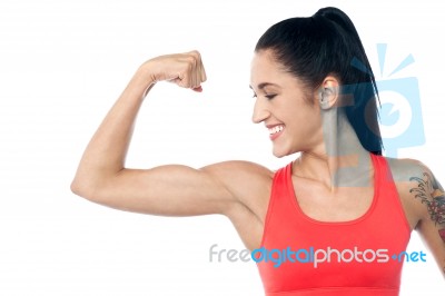 Female Trainer Showing Her Biceps Stock Photo
