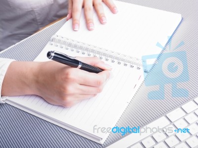 Female Writing On Notebook Stock Photo