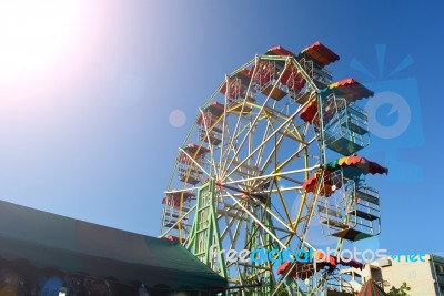 Ferris Wheel In Market With Sunlight And Clean Sky Background Stock Photo