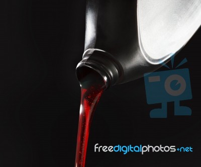 File Close Up Red Motor Oil Pouping From Black Plastic Bottle Ag… Stock Photo