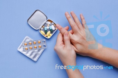 Finger Pain With Pills Stock Photo