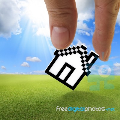 Fingers holding Up Pixel House Stock Photo