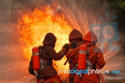 Firefighters Fighting Stock Photo