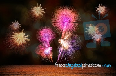 Firework Celebration From The Sea Shore Stock Photo
