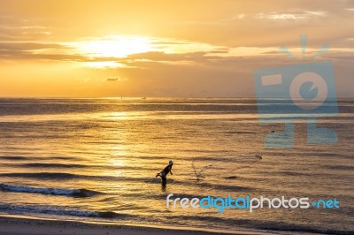 Fisherman Throwing Net , Fishing In The Morning On The Beach Stock Photo