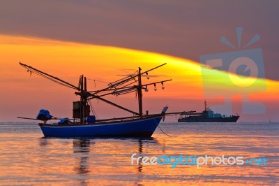 Fishing Boat At Sunrise Stock Photo