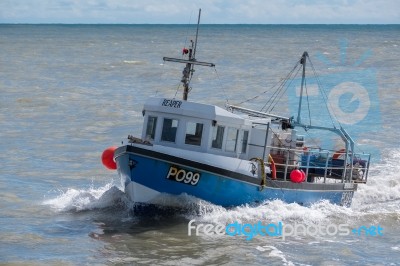 Fishing Boat Racing Home To Lyme Regis Harbour Stock Photo