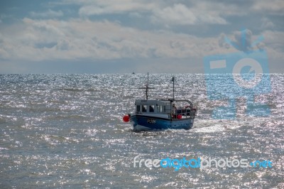 Fishing Boat Racing Home To Lyme Regis Harbour Stock Photo