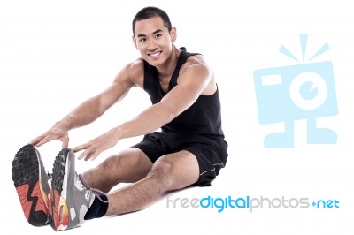 Fit Guy Doing Stretching Exercise Stock Photo