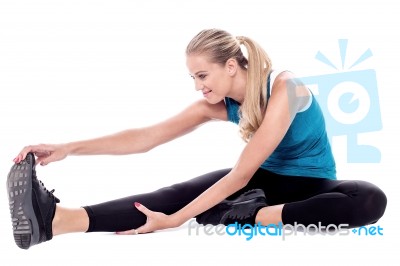 Fit Woman Stretching While Exercising Stock Photo