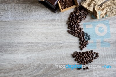 Flat Lay Of  Coffee Beans In Form Of Coffee Pouring From A Sack Stock Photo