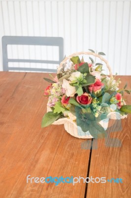 Flower Basket Decorated On Wooden Table Stock Photo