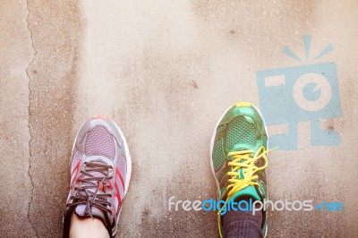 Foot With Shoes On Wall Stock Photo