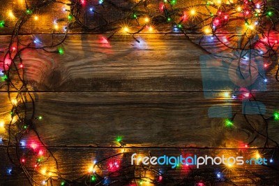 Frame Of The Colorful Christmas Festoon On The Wooden Board Stock Photo