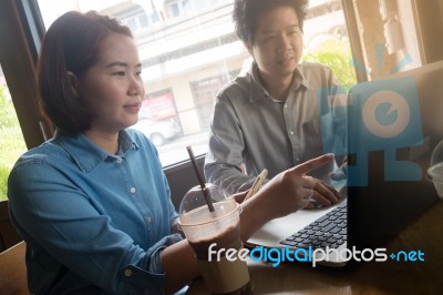 Freelance Workers Working Together In Cafe Stock Photo