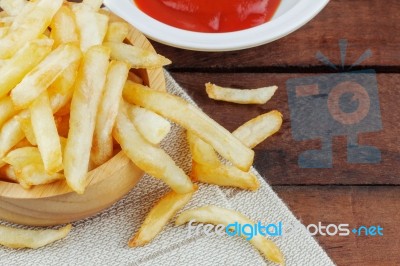 French Fries And Sauce On Wooden Stock Photo