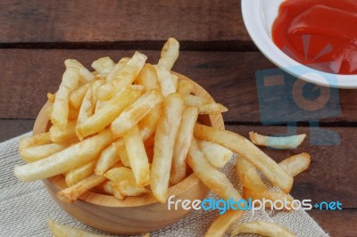 French Fries And Sauce On Wooden Stock Photo