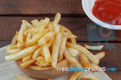 French Fries And Sauce On Wooden Stock Photo