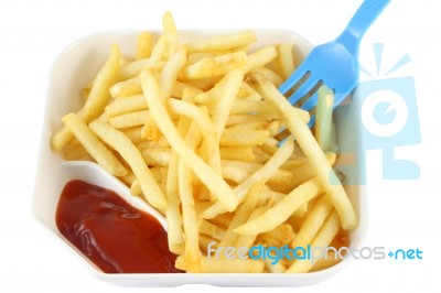 French Fries With Red Ketchup And Blue Spoon On Top Right Stock Photo