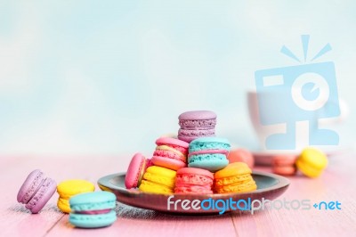 French Macarons On Pink Wooden Background. Vintage Style Stock Photo