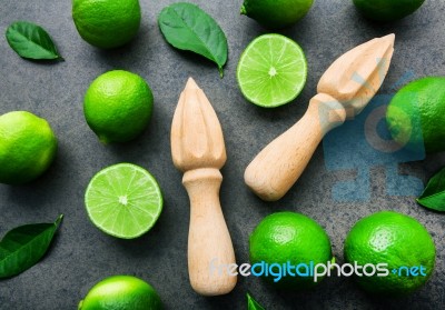 Fresh Limes And Wooden Juicer On White Background. Top View With… Stock Photo