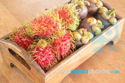 Fresh Rambutan And Mangosteen On Wooden Tray Stock Photo