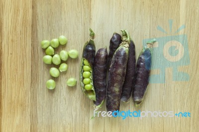 Fresh Ripen Peas Isolated On Wooden Background Stock Photo