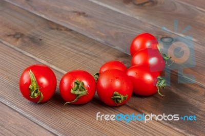 Fresh Tomatoes On The Dark Wooden Table Stock Photo