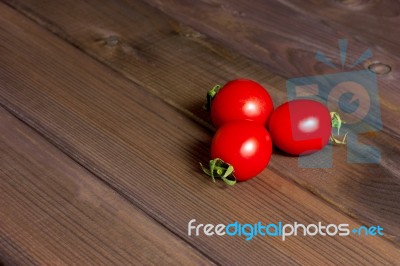 Fresh Tomatoes On The Dark Wooden Table Stock Photo