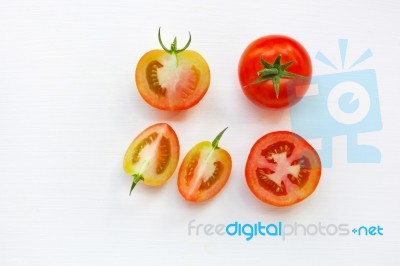 Fresh Tomatoes On White Wooden Background Stock Photo
