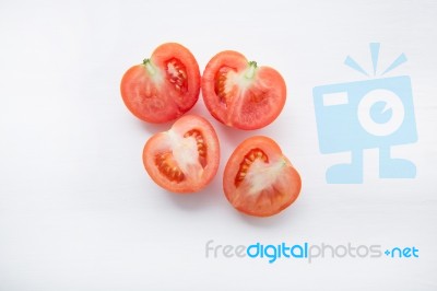 Fresh Tomatoes Slices On White Wooden Background Stock Photo
