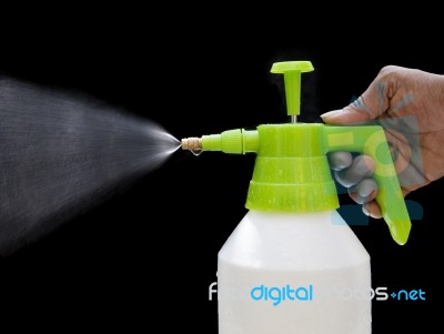 Fresh Water Spray From Bottle By Hand Isolated On Black Stock Photo