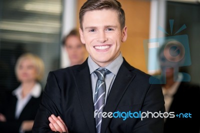 Friendly Business People With Male Leader In Front Stock Photo
