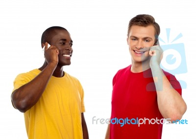 Friends Communicating On Cellphone Stock Photo