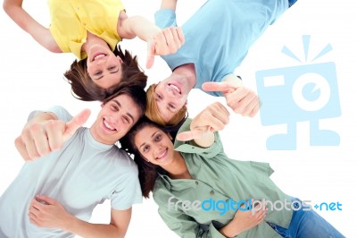 Friends Lying Down With Thumbs Up Stock Photo
