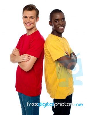 Friends Standing With Arms Crossed Stock Photo