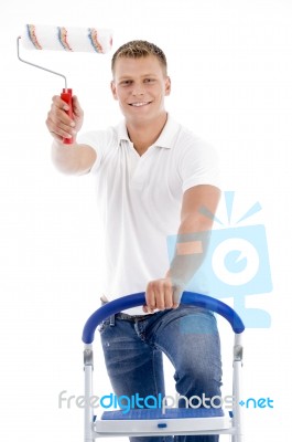 Front Pose Of Smiling Male Holding Brush Stock Photo