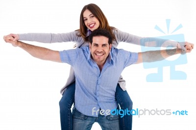 Front View Of A Couple In Piggy Back Ride Stock Photo