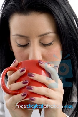 Front View Of Female Doctor Drinking Coffee On White Background Stock Photo